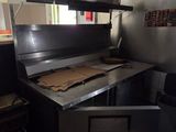 a kitchen with a stove, oven, and other items in it