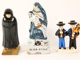 three figurines of people standing next to each other