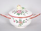 a white bowl with a bird on top of it