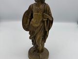 an old bronze statue of a roman soldier holding a shield and shield