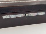 a wooden box with a mother of pearl in it