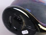 a black clock with a black face on a white surface