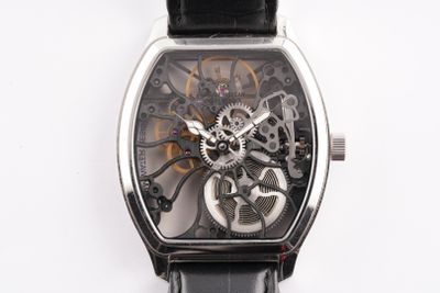 a close up of a watch on a white surface