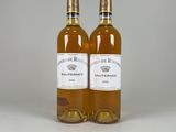 two bottles of wine sitting next to each other on a table