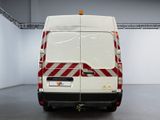 a white van with red and white stripes parked in a room