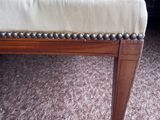 beige upholstered foot rest of a foot stool in a living room