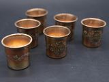 six cups of tea are lined up in a row on a table