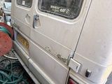 a white van that has a hose attached to the side of it