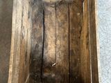 a wooden box that is sitting on the floor