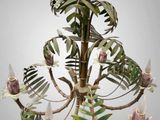 a chandelier that has a bunch of flowers on it