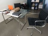 a desk with a chair and a laptop on it