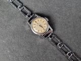 a watch that is sitting on a chain on a table