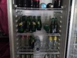 a refrigerator that has a lot of bottles of beer in it
