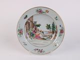 a plate with a painting on it sitting on a table