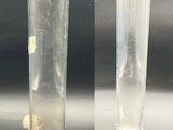 two different views of a glass vase with a coin in it