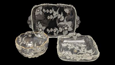 four pieces of glass with a design of flowers and leaves