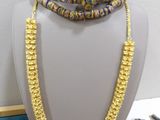 a close up of a necklace on a mannequin on a table