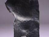 a black sculpture of a cat sitting on top of a table