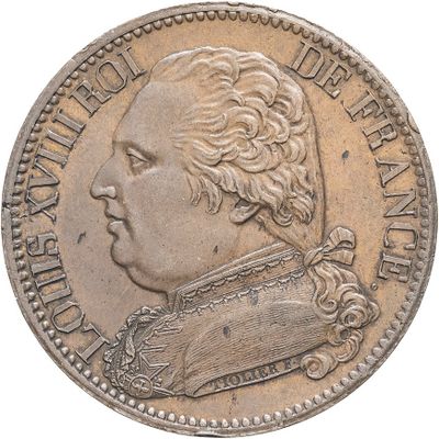 Gros plan sur une pièce de monnaie portant le visage d'un homme