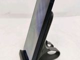 a cell phone that is on a stand on a table
