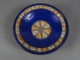 a blue plate with a decorative design on it
