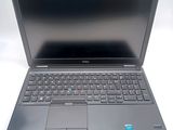 a dell laptop computer sitting on a white surface