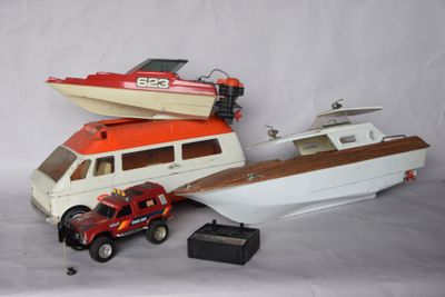 a toy boat and a toy truck next to a boat