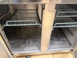 two shelves that are open on the inside of a refrigerator