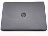 the back view of a laptop with the lid open on a white surface