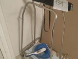 a bathroom with a toilet and a hand rail in it