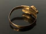an image of a close up of a gold ring on a table
