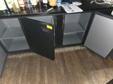 an image of a kitchen with a refrigerator and a lot of bottles