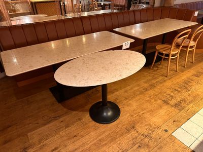 two tables and two chairs in the corner of a restaurant