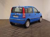 a small blue car that is parked on a checkered floor
