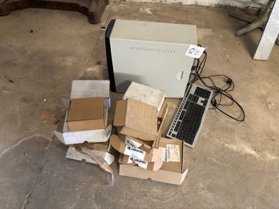 many boxes and a laptop on the floor next to a chair