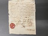 un morceau de papier portant un cachet de cire
