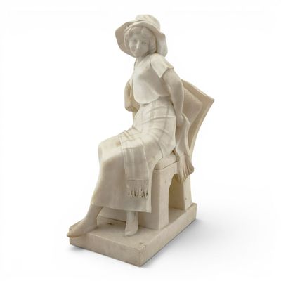 a statue of a woman sitting on a chair
