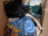 a cardboard box filled with clothes and other items