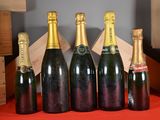 several bottles of wine are lined up on a table