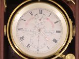 a clock with roman numerals on it in a wooden box