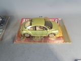 a green toy car sitting on top of a box
