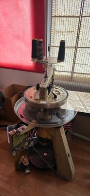 a table with a machine on top of it in front of a window