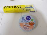 a tube of toothpaste next to a tube of toothpaste on a table