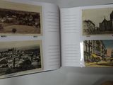 an open book with pictures of buildings and a clock on a table