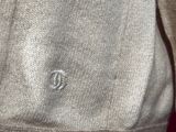 a close up of a sweater with a button on it