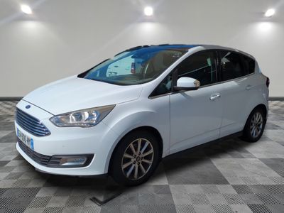 a white ford c - max parked on a checkered floor
