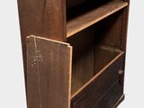 a wooden bookcase with a door open on a white background