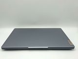a close up of a laptop computer on a white surface