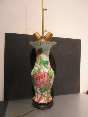 a lamp that is sitting on a table next to a wall