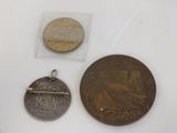 two coins and a coin are sitting on a table